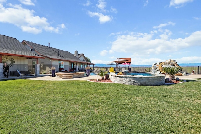 view of yard with a patio area, fence, a fenced in pool, and a jacuzzi