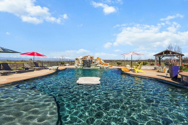 view of pool with a fenced in pool, fence, a gazebo, and a patio