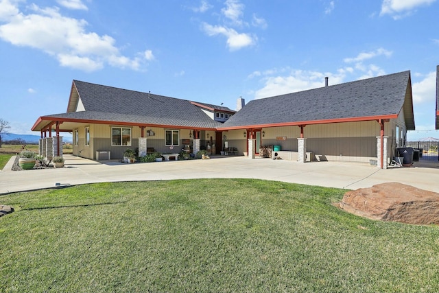 back of house featuring a patio area and a yard