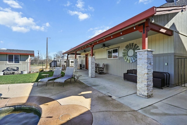 view of patio with ceiling fan and fence