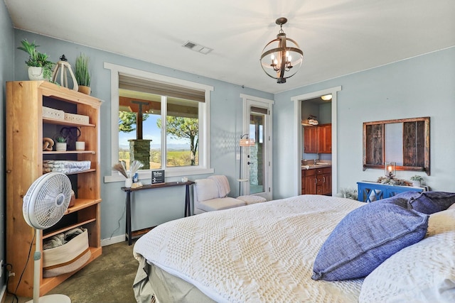 bedroom featuring a chandelier, visible vents, and baseboards