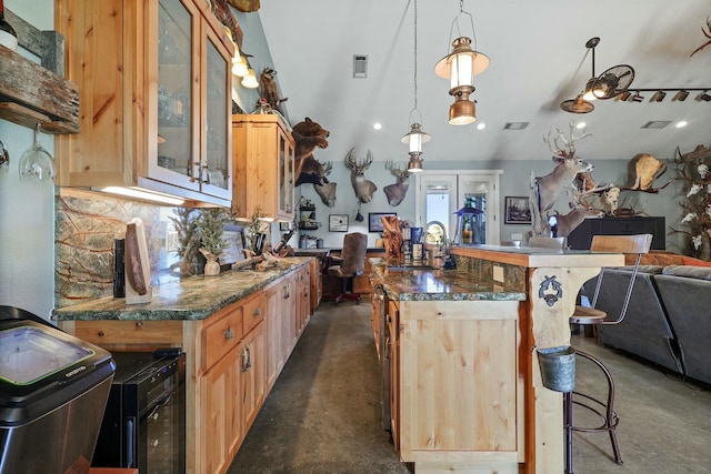 kitchen with a center island, visible vents, backsplash, open floor plan, and a kitchen breakfast bar