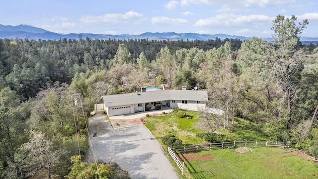 aerial view with a wooded view and a mountain view