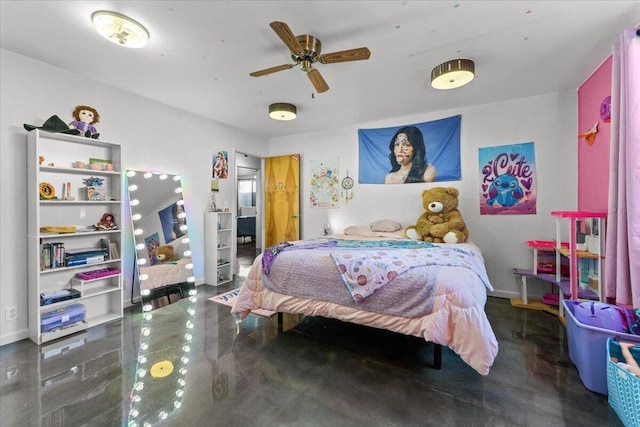 bedroom featuring concrete floors and baseboards