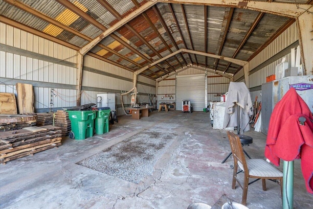 interior space with metal wall and unfinished concrete flooring