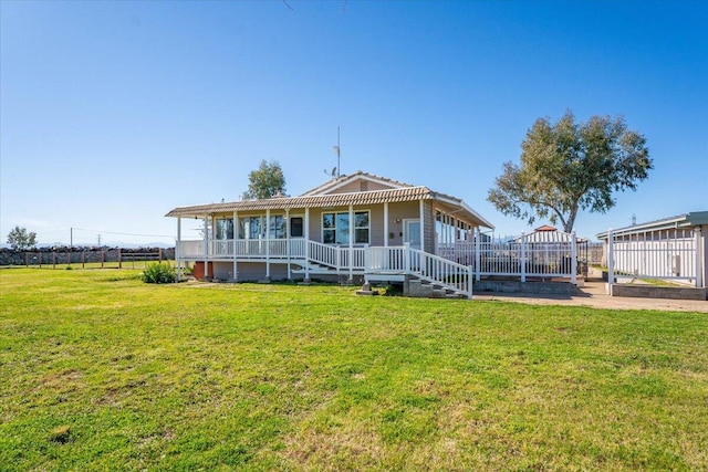 view of front of home with a front yard and fence