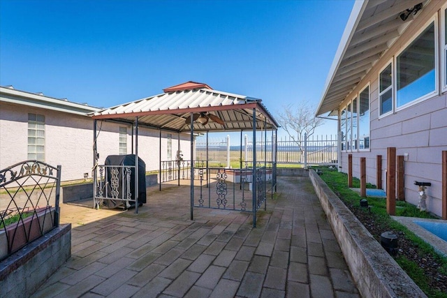 view of patio with a gazebo, grilling area, and fence