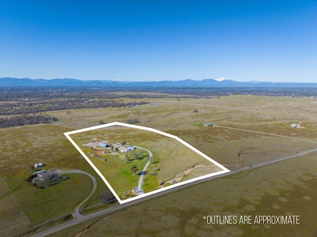 birds eye view of property with a rural view and a mountain view