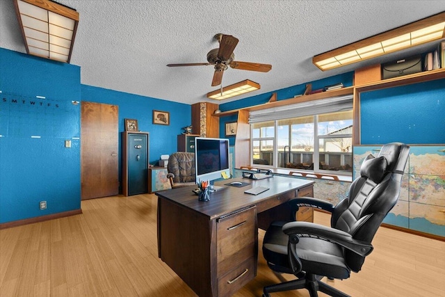 office area featuring ceiling fan, a textured ceiling, baseboards, and wood finished floors