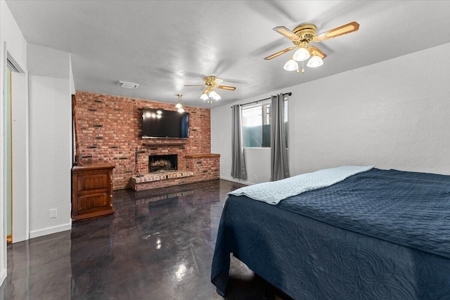 bedroom with finished concrete flooring, a brick fireplace, ceiling fan, and visible vents