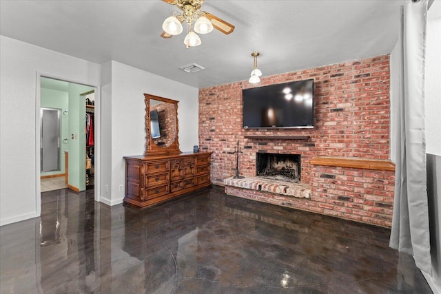 living room featuring a brick fireplace, brick wall, visible vents, and baseboards