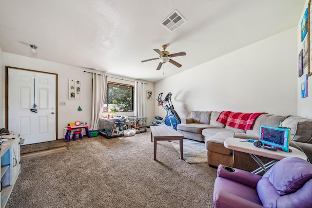 living room with carpet floors, visible vents, and a ceiling fan