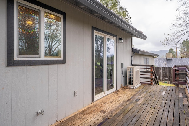 deck featuring fence and cooling unit