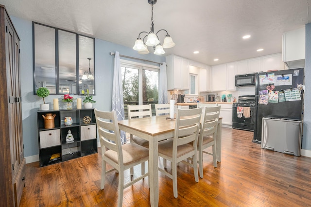 dining area with dark wood-style floors, recessed lighting, a notable chandelier, and baseboards