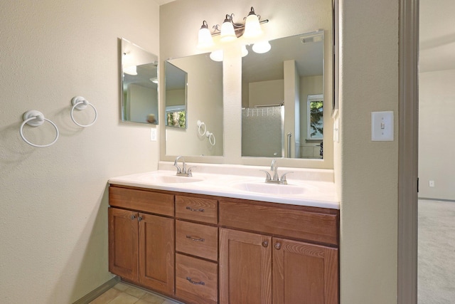 full bath featuring double vanity, visible vents, and a sink