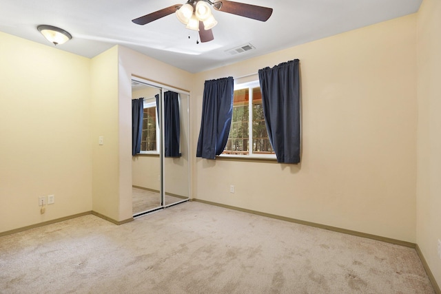 unfurnished bedroom with carpet, visible vents, and baseboards