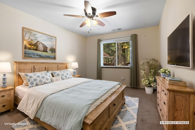 carpeted bedroom featuring ceiling fan and visible vents