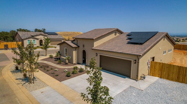 view of front facade with concrete driveway, fence, an attached garage, and stucco siding