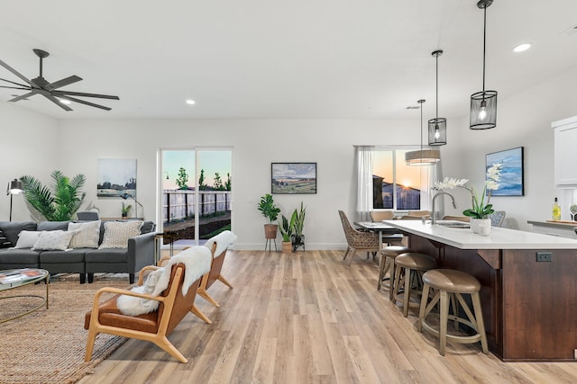 interior space with light wood finished floors, recessed lighting, visible vents, ceiling fan, and baseboards