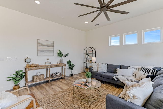 living area featuring baseboards, visible vents, a ceiling fan, light wood-style flooring, and recessed lighting