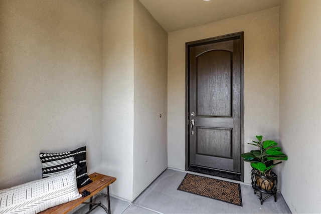 property entrance with stucco siding