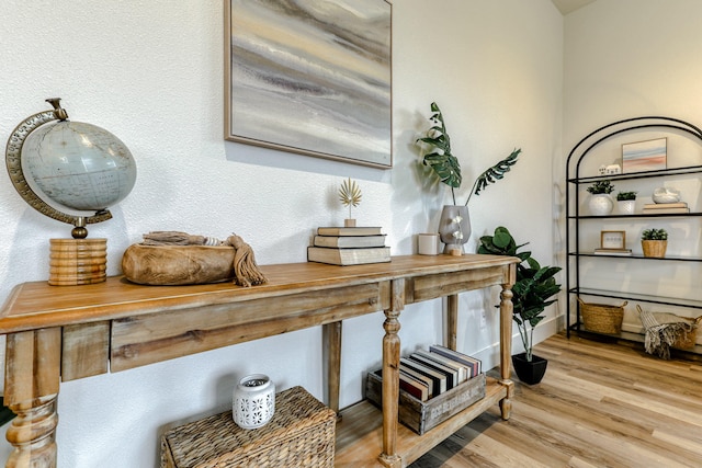 interior space with baseboards and wood finished floors