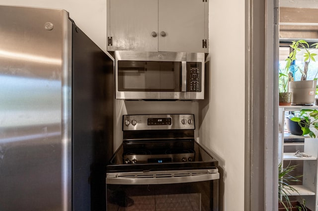 kitchen with stainless steel appliances and white cabinets