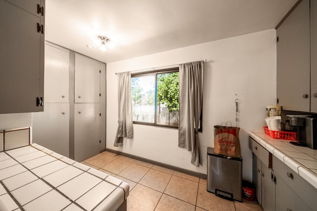 bedroom with light tile patterned floors and baseboards