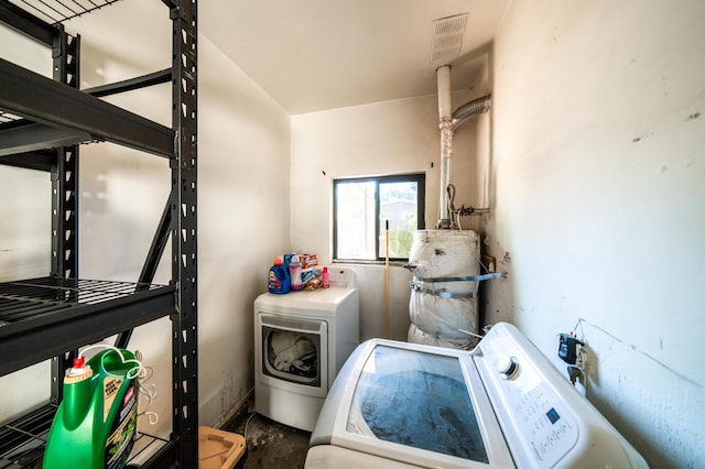 laundry room featuring laundry area, washing machine and clothes dryer, and visible vents