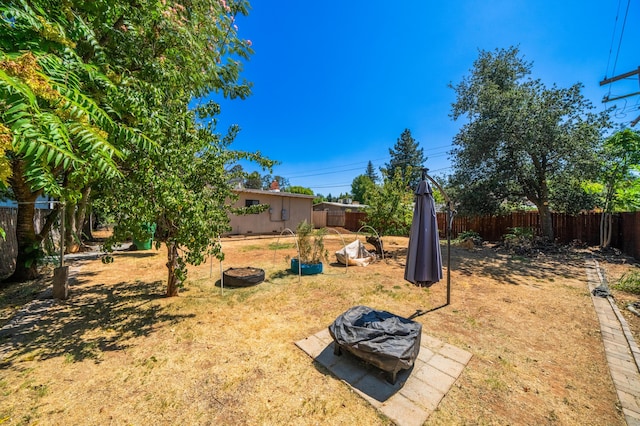 view of yard featuring an outdoor fire pit and a fenced backyard