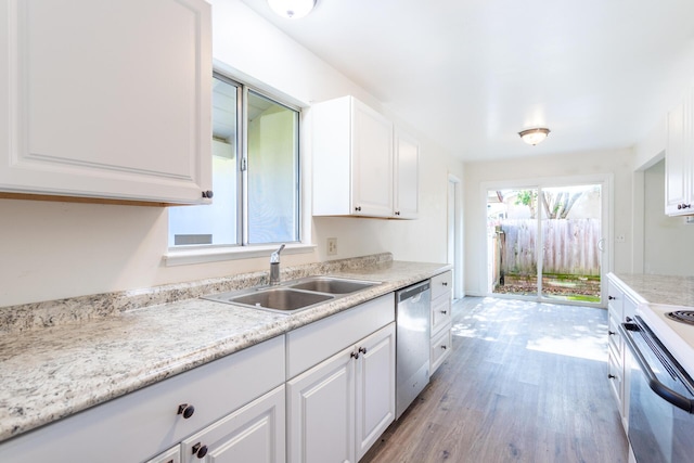 kitchen featuring a sink, white cabinetry, light countertops, stainless steel dishwasher, and white range with electric cooktop