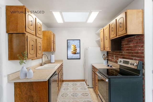 kitchen with baseboards, appliances with stainless steel finishes, light countertops, open shelves, and a sink