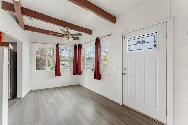 entrance foyer with beamed ceiling, a ceiling fan, baseboards, and wood finished floors