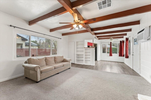 living area featuring visible vents, beam ceiling, carpet floors, baseboards, and ceiling fan