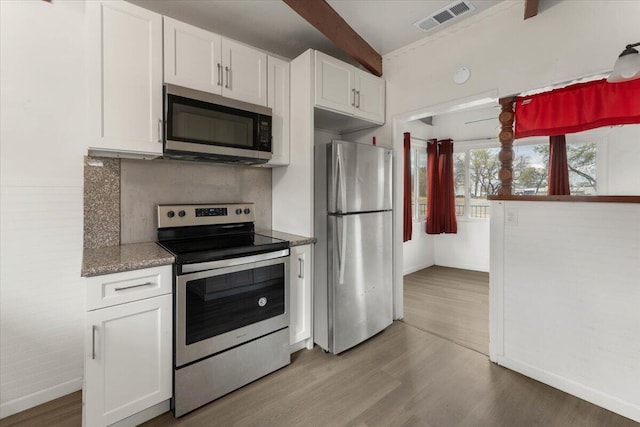 kitchen with white cabinets, light wood-style flooring, visible vents, and stainless steel appliances