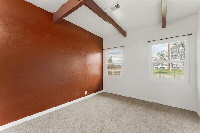 spare room featuring visible vents, carpet flooring, lofted ceiling with beams, and baseboards