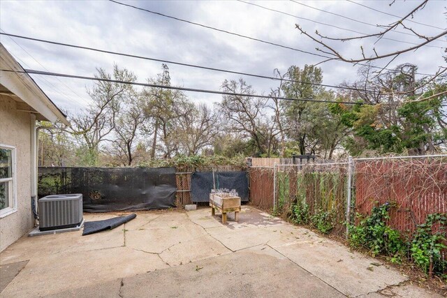 view of patio featuring a fenced backyard and central AC