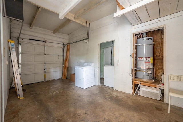 garage featuring secured water heater and washer / dryer