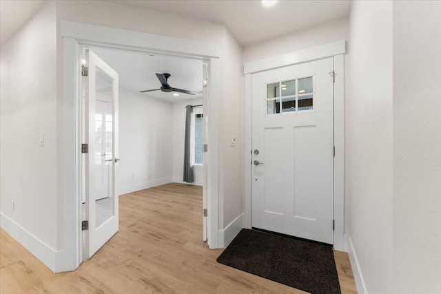 foyer entrance with light wood-type flooring and baseboards