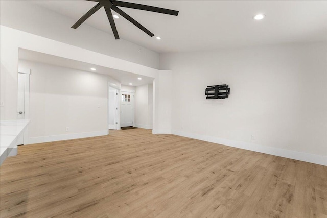 spare room with light wood finished floors, a ceiling fan, and recessed lighting