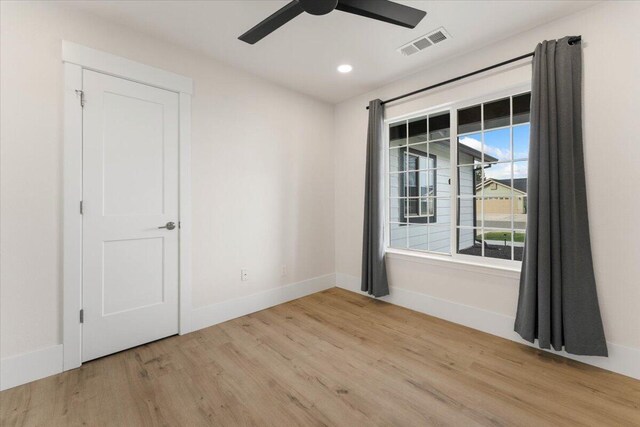 unfurnished room with baseboards, visible vents, a ceiling fan, wood finished floors, and recessed lighting