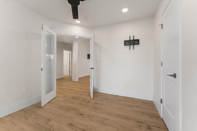 interior space with a ceiling fan, recessed lighting, light wood-style flooring, and baseboards