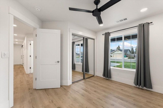 unfurnished bedroom with recessed lighting, visible vents, baseboards, light wood-style floors, and a closet