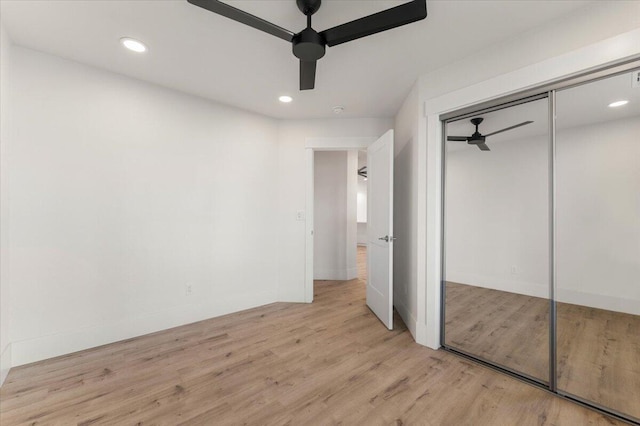 unfurnished bedroom featuring recessed lighting, a closet, ceiling fan, and wood finished floors