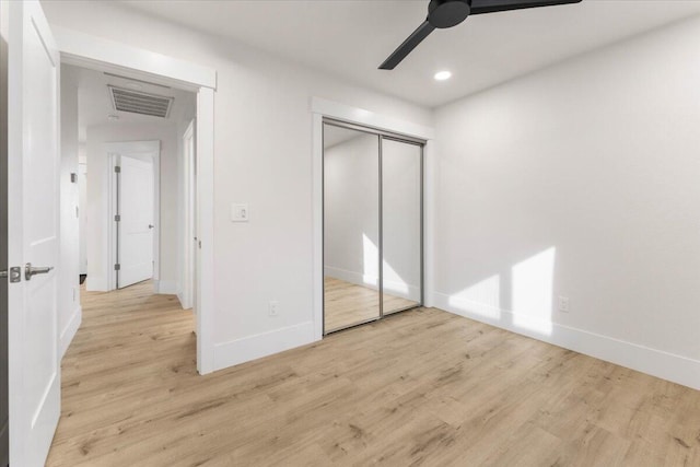 unfurnished bedroom featuring recessed lighting, a closet, visible vents, wood finished floors, and baseboards