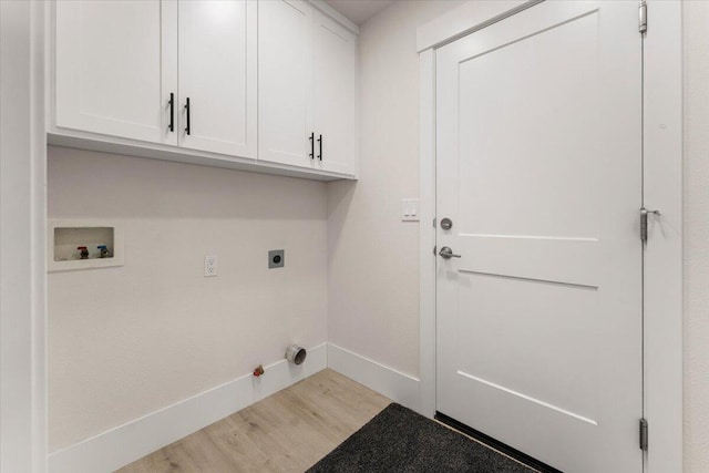 washroom featuring cabinet space, hookup for a gas dryer, wood finished floors, washer hookup, and electric dryer hookup