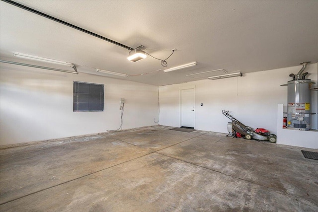 garage with water heater and a garage door opener