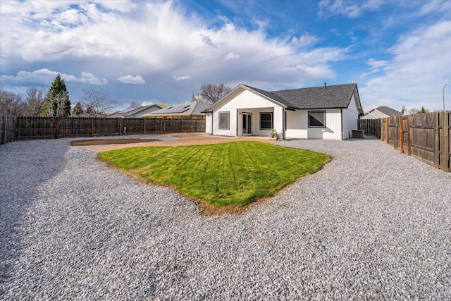 back of house featuring a yard, a fenced backyard, and a patio