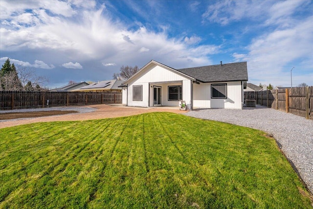 back of house featuring a patio, a lawn, and a fenced backyard