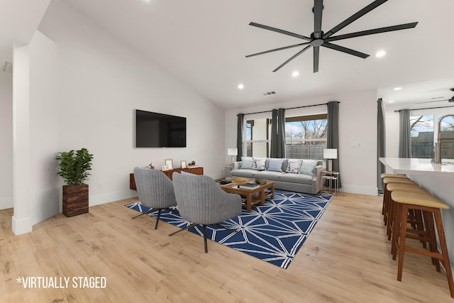 living area with light wood-style floors, plenty of natural light, and visible vents